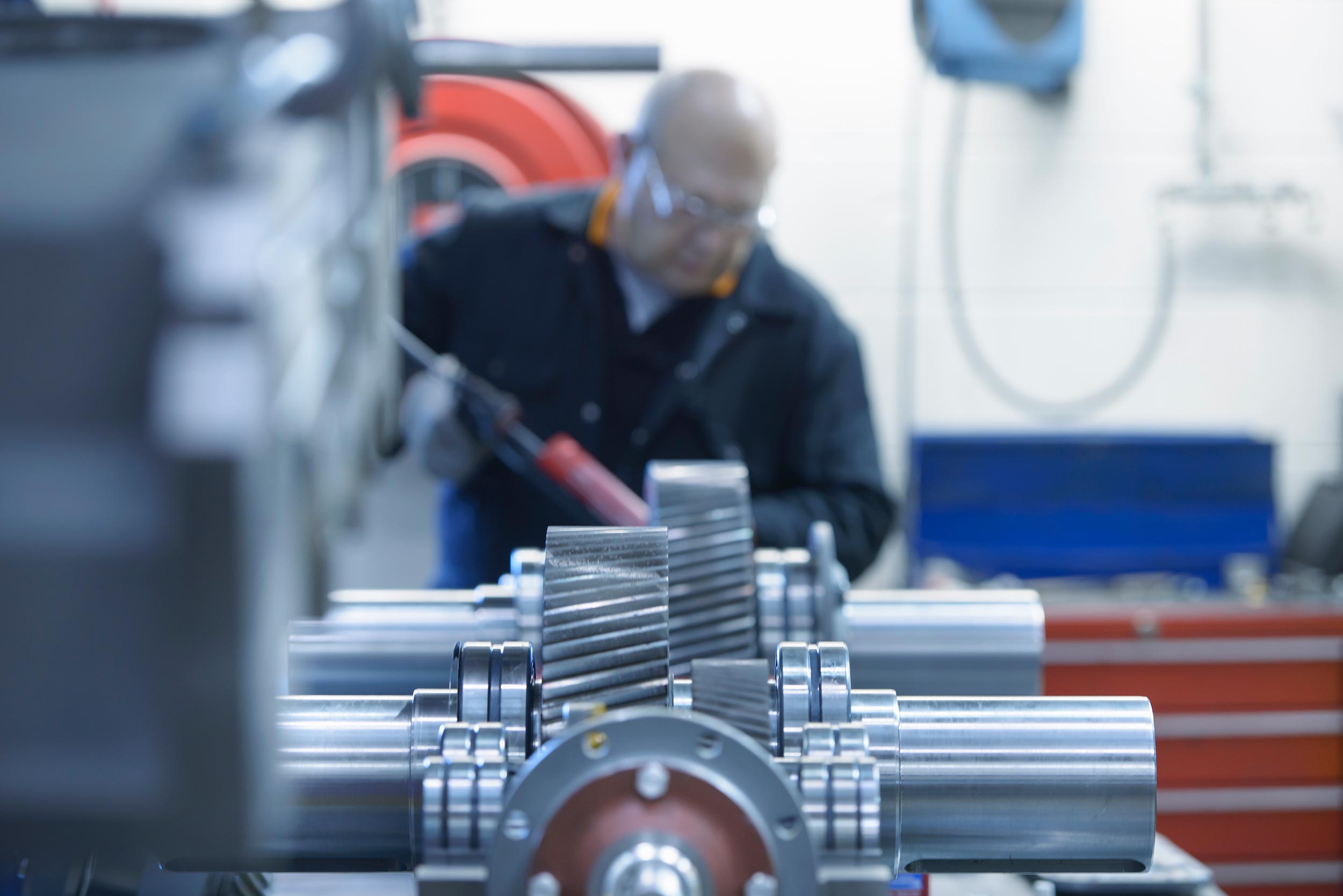 Symbolic representation of an engineer applying sealant to an Industrial Gearbox (gear unit)